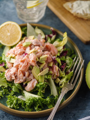 Ceviche is a traditional dish from Peru. Salmon marinated in lemon with fresh lettuce, avocado and onions