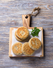 Bean cutlets with herbs and spices on a wooden board on a wooden table, rustic style, top view, free space. delicious vegetarian food