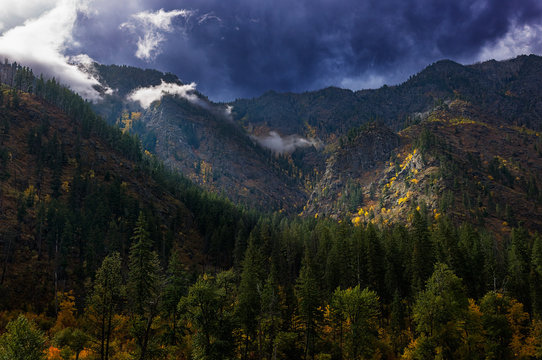 Stormy autumn sky with the sun breaking through over the mountains in North Central Washington