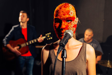 Fototapeta na wymiar Masked female singer