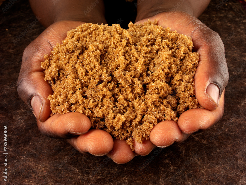 Wall mural MAN HOLDING DARK RAW BROWN SUGAR