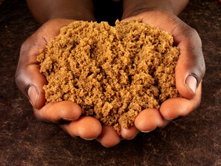 MAN HOLDING DARK RAW BROWN SUGAR