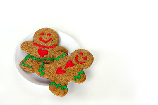 Christmas Gingerbread Man and Woman on Plate Isolated with Text Merry Christmas