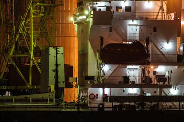 Wheelhouse of the cargo ship. Cargo port at night © Oleksandra