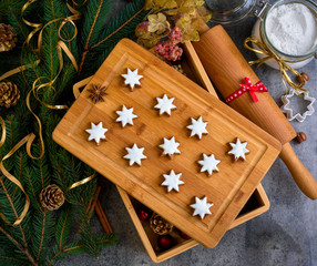 Christmas gingerbread with decoration on a wooden board. Top view.