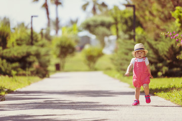 Fototapeta premium little girl runing in the summer Park