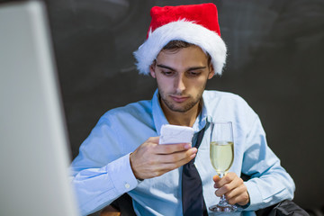businessman with mobile phone in the office at christmas