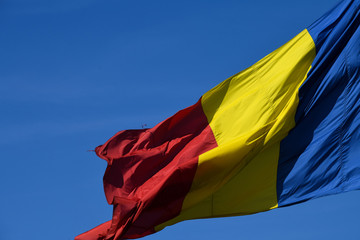 Romanian national flag in the wind on a sunny day.