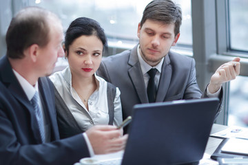 rear view.group of business people using laptop in office