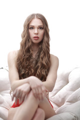 Naklejka premium close up.sexy young woman sitting in a big white chair
