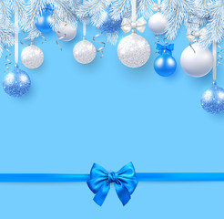 Blue Christmas and New Year background with fir branches, Christmas balls and satin bow.