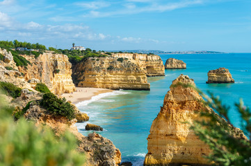 Fototapeta premium Cliffs and sea in sunny day near by Benagil Beach, Portugal, popular travel and holiday destination in Europe