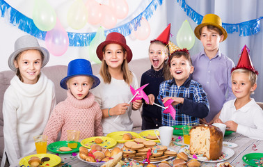 children having celebration of friend’s birthday during dinner