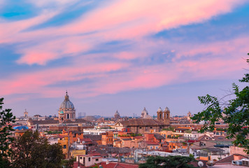 Fototapeta na wymiar Aerial wonderful view of Rome with roofs and churches at sunset time in Rome, Italy