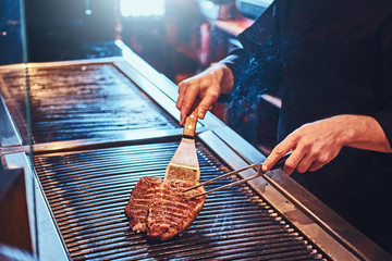 Cropped photo of a chef cooking delicious beef steak