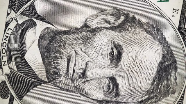 US President Abraham Abe Lincoln face on 5 dollar bill rotate, 4K ultra hd video