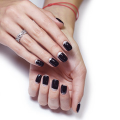 Fototapeta premium Beautiful hand with black manicure nails
