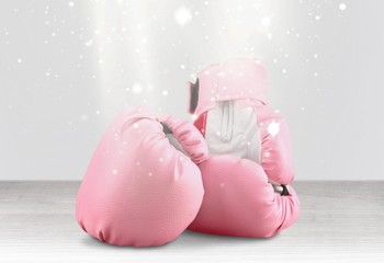 Pink boxing gloves on background