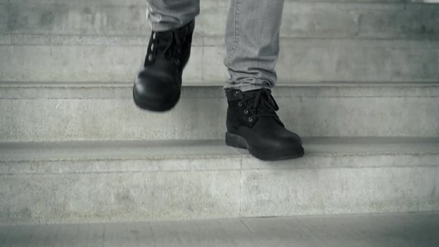 Man in black boots going downstairs