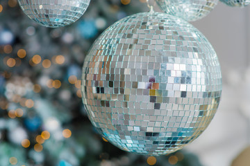 Shiny big blue ball on the background of the Christmas tree