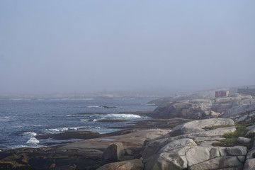 Peggy’s Cove, Nova Scotia, Canada: Small fishing village on a rocky coast, on a foggy morning.