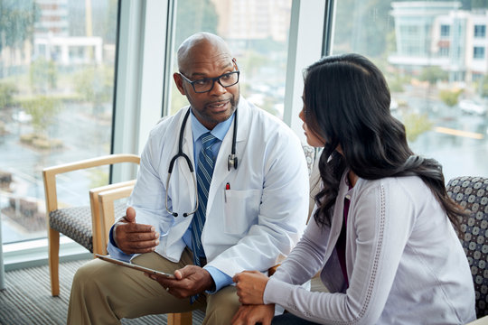 Doctor talking to woman in medical office
