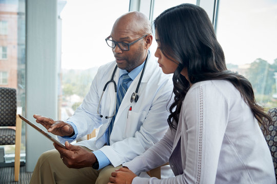 Doctor talking to woman in medical office