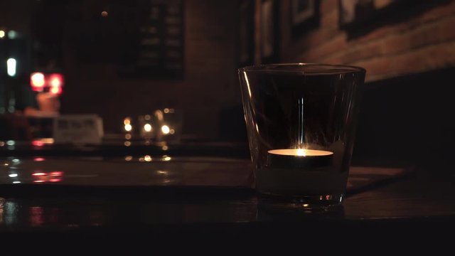 Candles burning on restaurant table setting a nice ambiance for customers.
