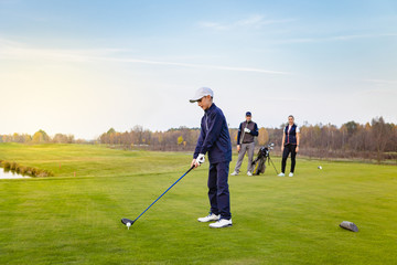 Happy family is playing golf in autumn
