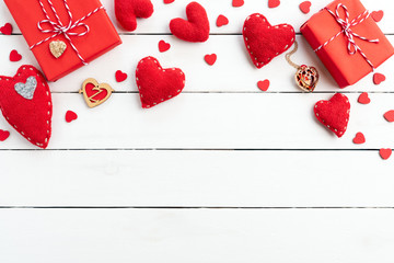 Valentines day background concept. Top view of Red gift box with handmade red heart on white wooden background.
