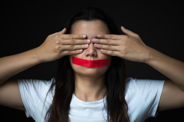 Young woman was wrapping her mount by adhesive tape,  Concept freedom of speech, censorship,...