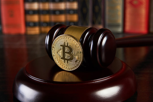 Crypto currency law, judge gavel, stacked legal book and bitcoin