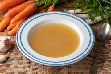 Chicken bone broth in a white plate