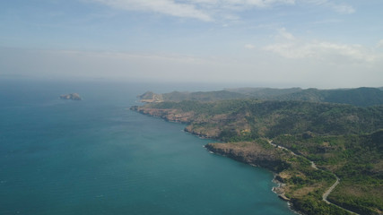 Obraz premium Aerial view of seashore with lagoons and coral reefs. Philippines, Luzon. Coast ocean with turquoise water. Tropical landscape in Asia.