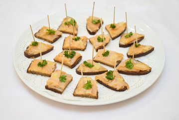 Canape with smoked fish, cream cheese and dill on rye bread