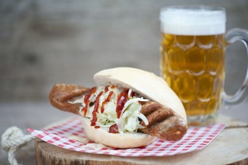 Traditional German food -  sausage with sauerkraut and bun with beer. Oktoberfest . Fried sausages on sauerkraut .
