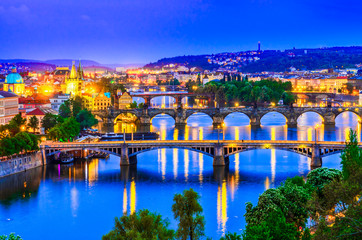 Fototapeta na wymiar Prague, Czech republic: Night view over the Vltava river and its bridges at sunset