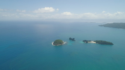 Aerial view islands with sand beach Lahus and turquoise water in blue lagoon among coral reefs, Caramoan Islands, Philippines. Landscape with sea, tropical beach.