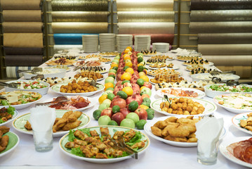 Catering table set service with cold snacks, canapes, fruits and