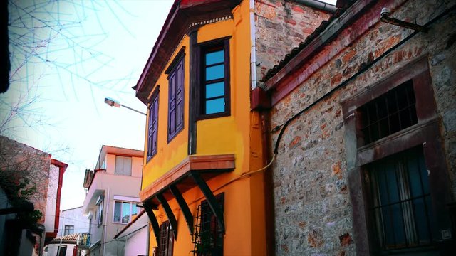 Old, yellow aegean townhouses. Izmir city of Turkey, near Greek Island has wooden, rock, antique house. 