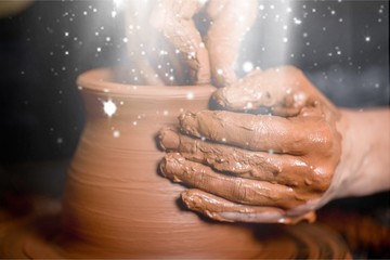 Hands of potter making clay pot, closeup photo