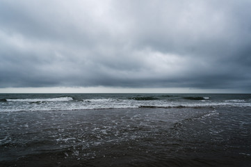 Fototapeta na wymiar wild sea on a grey / rainy day