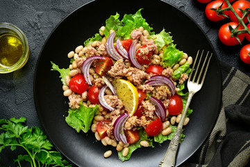 Tuna salad with tomatoes and white bean.Top view with copy space.