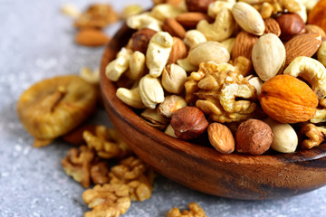 Wooden bowl with nuts ( pistachio, walnut, hazelnut, cashew, almond)  and dried fruits.