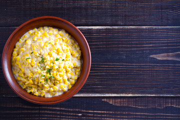 Sweet and creamy corn in bowl. Corn dish. overhead, horizontal