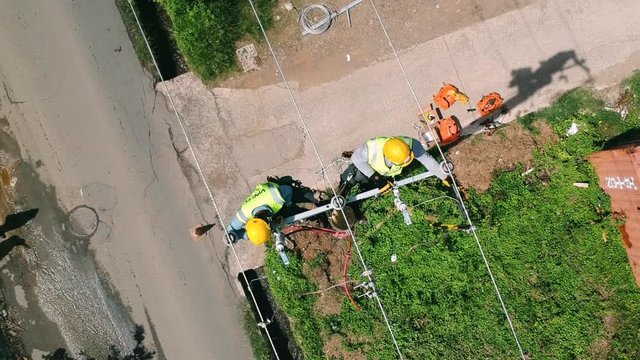 Aerial shot of two working men, restoring the power lines after Hurricane Irma on Tortola in 2017