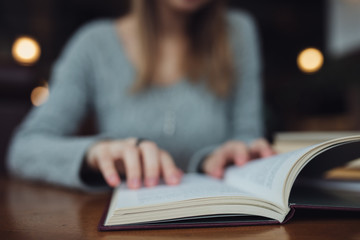Woman reading book close up