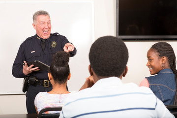 Officer teaching community outreach class full of students