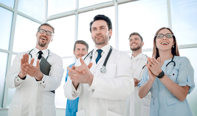 Fototapeta na wymiar Five different doctors standing and applauding
