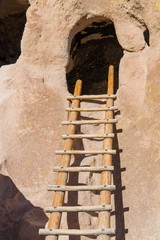 Wood ladder leading to an abandoned cliff dwelling in a cave in Bandelier National Monument near...